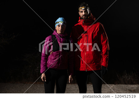trail runners couple portrait while preparing for an early morning run in the night time with a headlamp 120452519