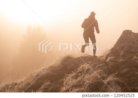 trail running woman athlete training for ultra-marathon race in a mountain 120452525