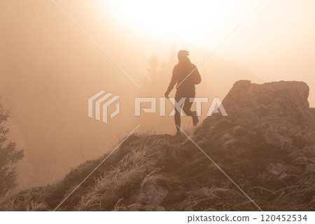 trail running woman athlete training for ultra-marathon race in a mountain 120452534