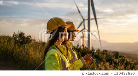 Female engineers using tablets to monitor and manage wind turbine operations on site.Generated image Female engineers using tablets to monitor and manage wind turbine operations on site.Generated image 120452650