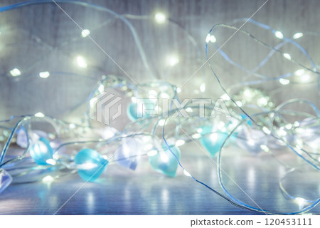 Christmas lights on wooden background 120453111