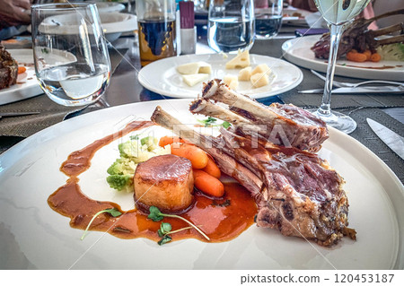 Main dish lamb, tape, broccoli carrot boy on white plate 120453187