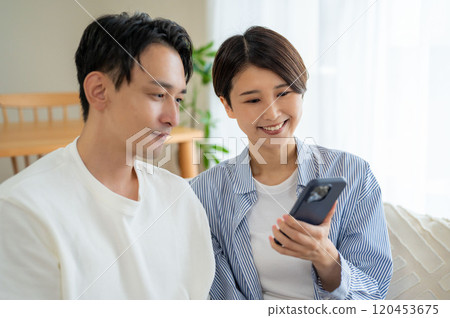 Gender watching smartphone Gender watching smartphone 120453675