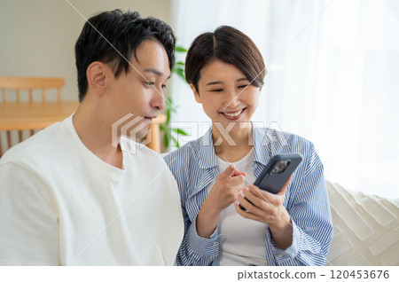 Men and women looking at a smartphone Men and women looking at a smartphone 120453676