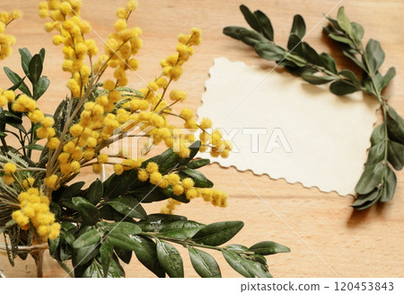 Bouquet of yellow mimosa flowers on wooden background with card 120453843