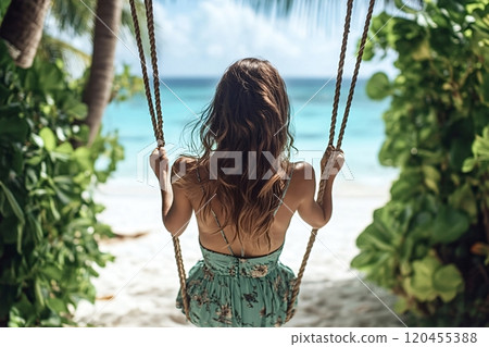 Tourist enjoying freedom swinging on tropical beach paradise Tourist enjoying freedom swinging on tropical beach paradise 120455388