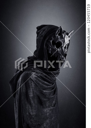 Creepy figure with animal skull at night over dark misty background Creepy figure with animal skull at night over dark misty background 120455719