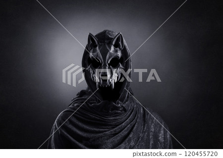 Creepy figure with animal skull at night over dark misty background Creepy figure with animal skull at night over dark misty background 120455720