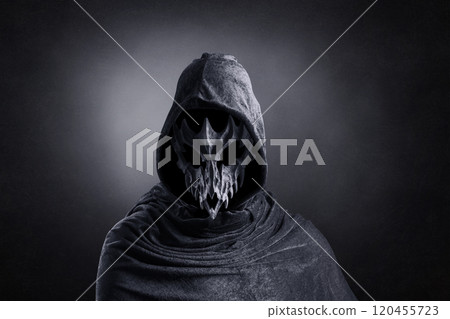 Creepy figure with animal skull at night over dark misty background 120455723