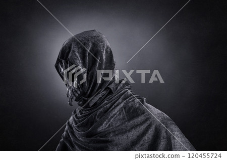 Creepy figure with animal skull at night over dark misty background Creepy figure with animal skull at night over dark misty background 120455724