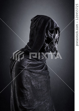 Creepy figure with animal skull at night over dark misty background 120455725
