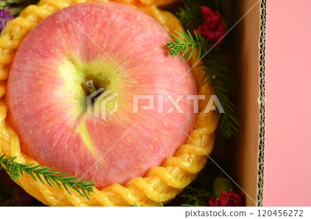 beautiful apple in the box on pink background, healthy fruit 120456272