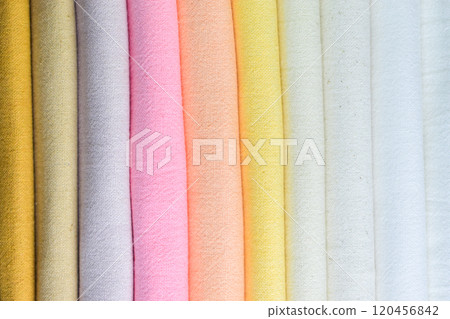 stack of colourful cotton clothes, pile of clothing on white background 120456842