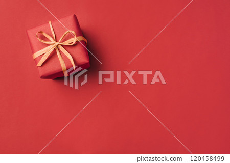 Gift boxe with brown bow on a red backdrop. Top view. Gift boxe with brown bow on a red backdrop. Top view. 120458499
