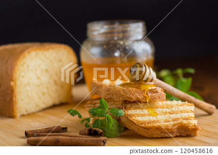 bread fried sweet toasts with honey on wooden board with cinnamon bread fried sweet toasts with honey on wooden board with cinnamon 120458616