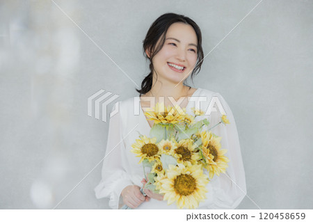 A woman holding a sunflower bouquet 120458659