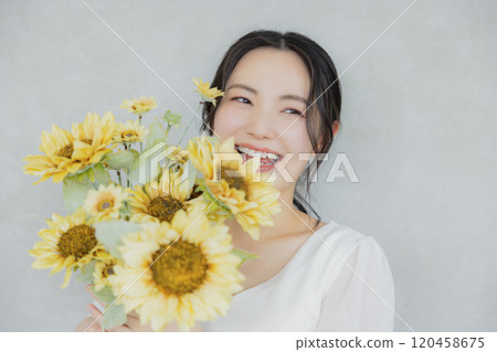 A woman holding a sunflower bouquet A woman holding a sunflower bouquet 120458675