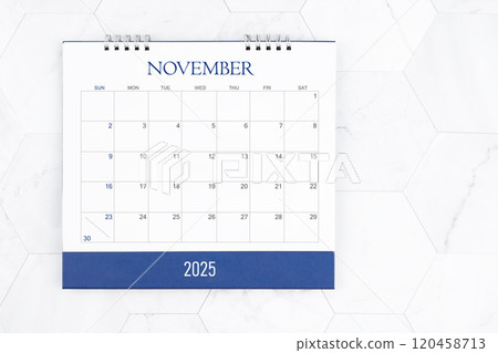 Directly above view of November 2025 desk calendar on white marble tiles. 120458713