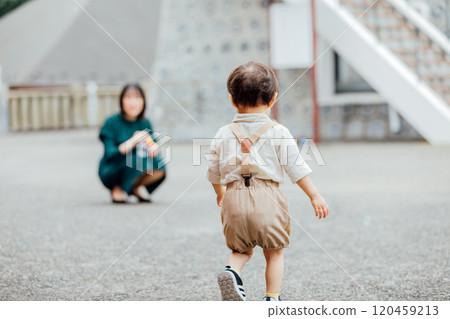 Mother and boy playing outside 120459213