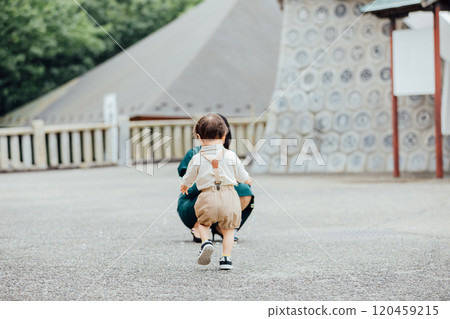 Mother and boy playing outside 120459215