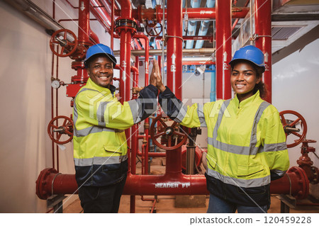 Electrical engineer team are working in control room. Electrical engineer man checking Power Distribution Cabinet in the control room 120459228