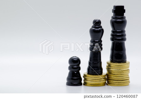 Status and Ambition Represented by black Pawns on Golden Coins. Status and Ambition Represented by black Pawns on Golden Coins. 120460087
