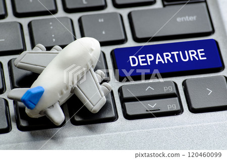 Departure text on laptop keyboard with airplane toy. Travel and destination concept 120460099