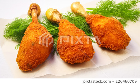 Crispy delight, Breaded chicken legs on a white isolated background, a mouthwatering visual for stock photos. 120460709