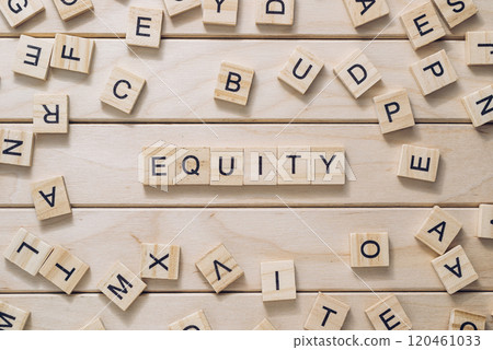 A wooden board with a jumble of letters scattered across it 120461033