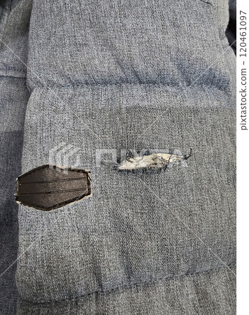 Blue fabric ripped at the sleeve. Blue fabric ripped at the sleeve. 120461097