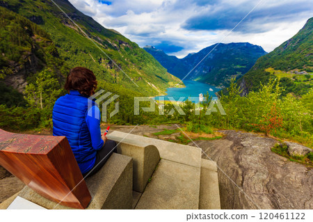 Tourist enjoying Geirangerfjord from viewing point Tourist enjoying Geirangerfjord from viewing point 120461122
