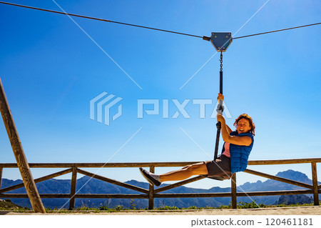 Adult woman having fun on zipline 120461181