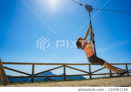 Adult woman having fun on zipline 120461186