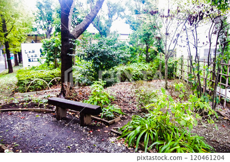 A smoking area surrounded by greenery next to the station 120461204