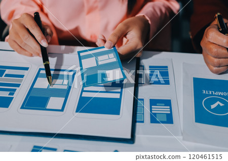 Young Asian business creative team work together, mobile application software design project. Brainstorm meeting, internet technology, smartphone web app designer, office coworker teamwork concept Young Asian business creative team work together, mobile application software design project. Brainstorm meeting, internet technology, smartphone web app designer, office coworker teamwork concept 120461515