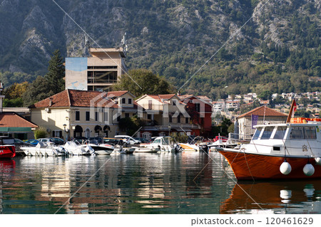View of Kotor buildings from the bay, boats against the backdrop of buildings. View of Kotor buildings from the bay, boats against the backdrop of buildings. 120461629