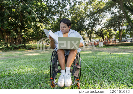 Young Man in Wheelchair Working Outdoors with Laptop in a Park Setting, Embracing Nature and Technology for a Productive Day Young Man in Wheelchair Working Outdoors with Laptop in a Park Setting, Embracing Nature and Technology for a Productive Day 120461683