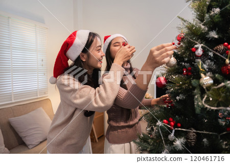 Joyful Lesbian Couple Celebrating Special Day with Thoughtful Reflections and Festive Cheer in a Cozy Home Setting Joyful Lesbian Couple Celebrating Special Day with Thoughtful Reflections and Festive Cheer in a Cozy Home Setting 120461716