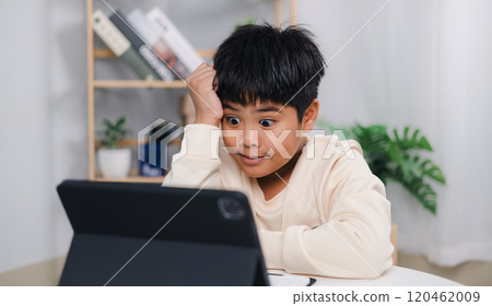 Educational of tech concept, Staying at home, Asian boy student using tablet learning. Presenting a modern educational way of life. Virtual internet online class from school teacher. 120462009