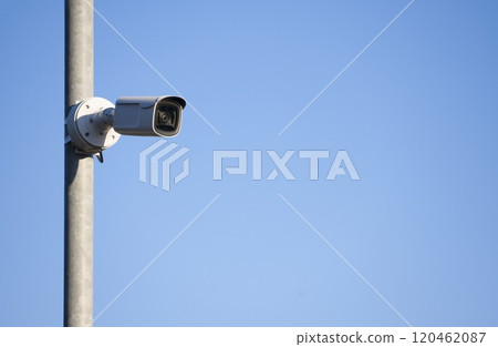 Security camera against a clear blue sky Security camera against a clear blue sky 120462087