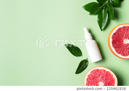 bottle of grapefruit essential oil and fresh citrus 120462816
