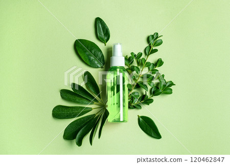 Body spray cosmetic product over green leaves 120462847