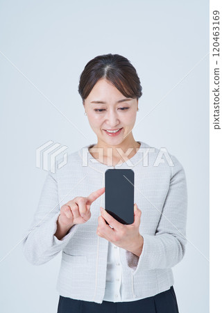 A woman operating a smartphone 120463169