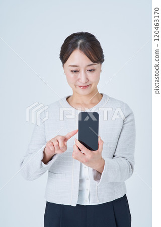 A woman operating a smartphone 120463170