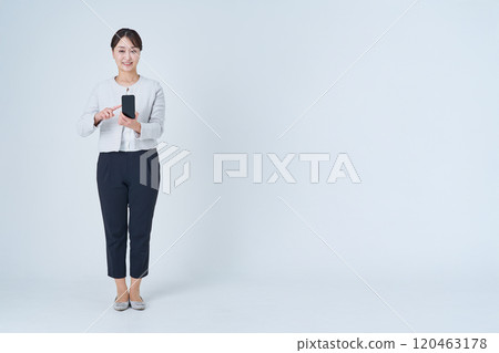 A woman operating a smartphone A woman operating a smartphone 120463178