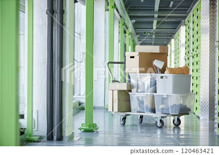 Background shot of cardboard and plastic boxes storing personal belongings loaded on dolly cart in hallway of self storage warehouse during moving out or apartment decluttering, copy space Background shot of cardboard and plastic boxes storing personal belongings loaded on dolly cart in hallway of self storage warehouse during moving out or apartment decluttering, copy space 120463421