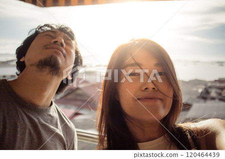 Couple lover enjoy the funny dance moment together with warm sunset. 120464439