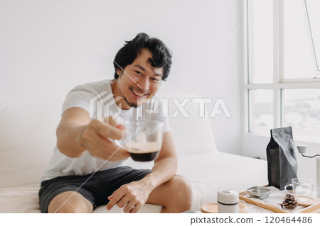 Happy healthy man offering his espresso coffee to the camera and smile. Happy healthy man offering his espresso coffee to the camera and smile. 120464486