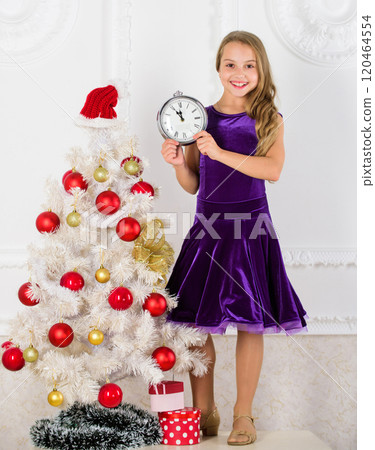 How much time left. Last minute till midnight. New year countdown. Last minute new years eve plans that are actually lot of fun. Girl kid santa hat costume with clock counting time to new year 120464554