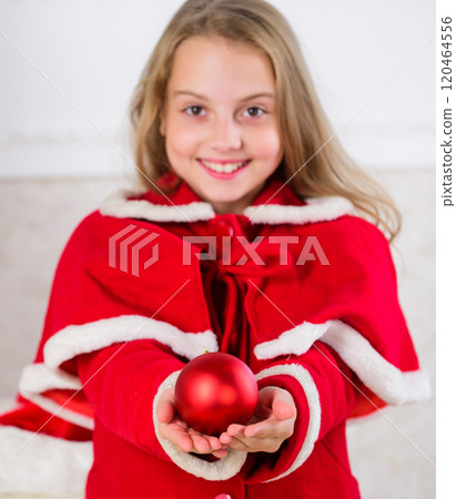 Child red costume hold christmas ornament ball. Kids can brighten up christmas tree by creating their own ornaments. Christmas ball traditional decor. Top christmas decorating ideas for kids room 120464556